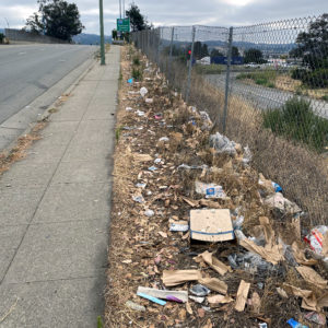 Trash strewn along a sidewalk
